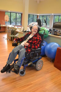 A Beechwood client smiles as he prepares for physical therapy. 