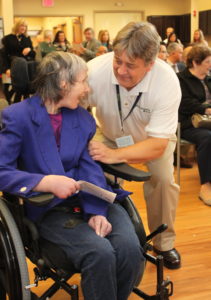 A Beechwood client smiles while speaking with a Beechwood staff member.